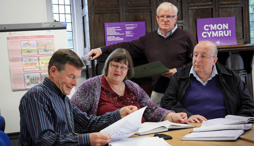 Four members of Glyn Wylfa discuss papers about their community